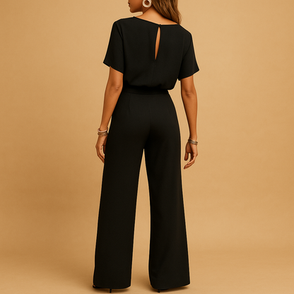 Woman wearing an elegant formal jumpsuit with a tailored fit and flowing sleeves, suitable for galas, weddings, and stylish evening occasions.