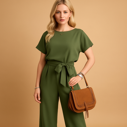 Woman wearing an elegant formal jumpsuit with a tailored fit and flowing sleeves, suitable for galas, weddings, and stylish evening occasions.