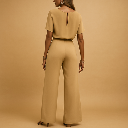 Woman wearing an elegant formal jumpsuit with a tailored fit and flowing sleeves, suitable for galas, weddings, and stylish evening occasions.