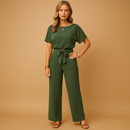 Woman wearing an elegant formal jumpsuit with a tailored fit and flowing sleeves, suitable for galas, weddings, and stylish evening occasions.